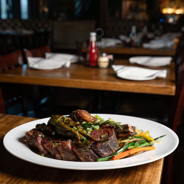Sliced steak with shishito peppers and vegetables