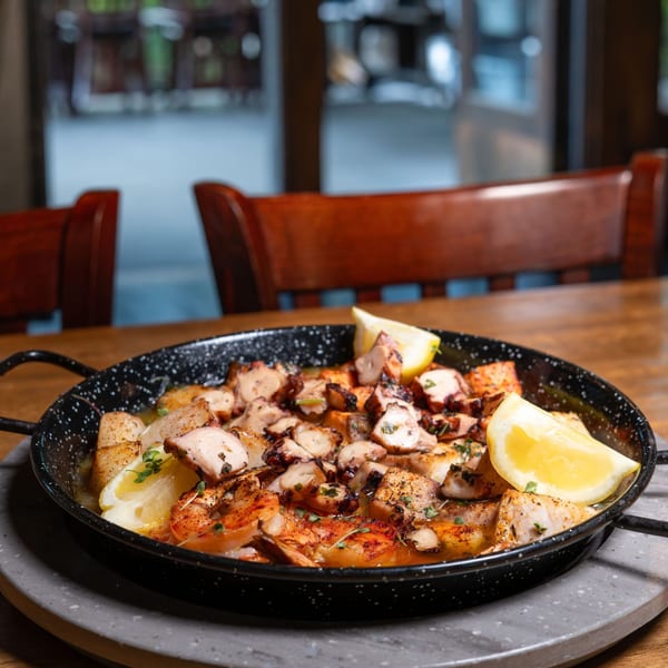Grilled octopus and shrimp skillet with lemon